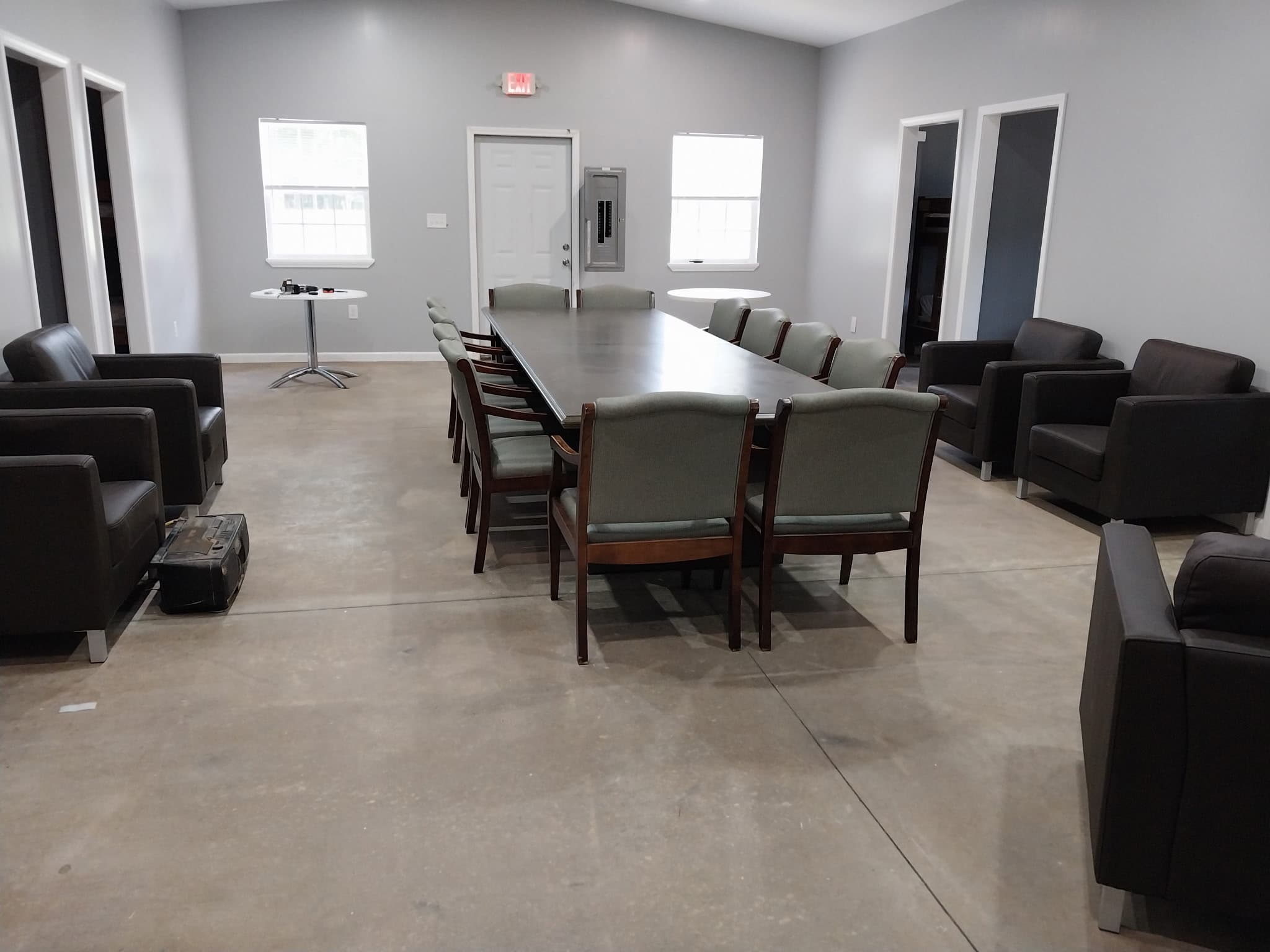 Camp Legacy dining hall with conference table and armchairs