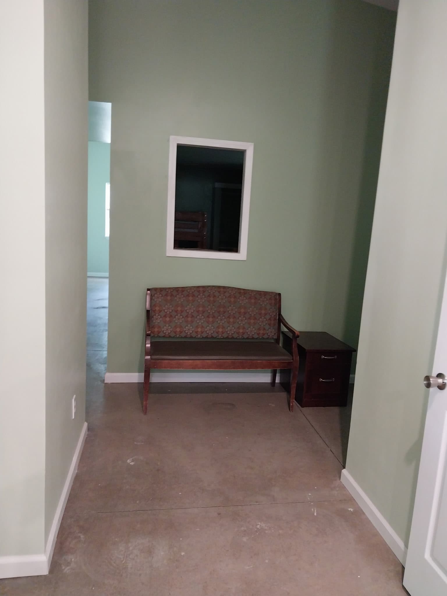 Hallway nook with bench and mirror at Camp Legacy