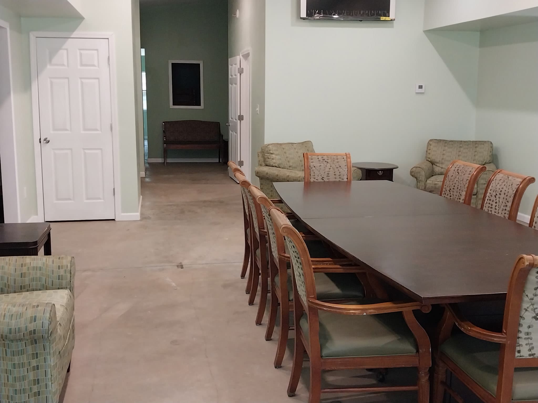 Camp Legacy common room with dining table and hallway